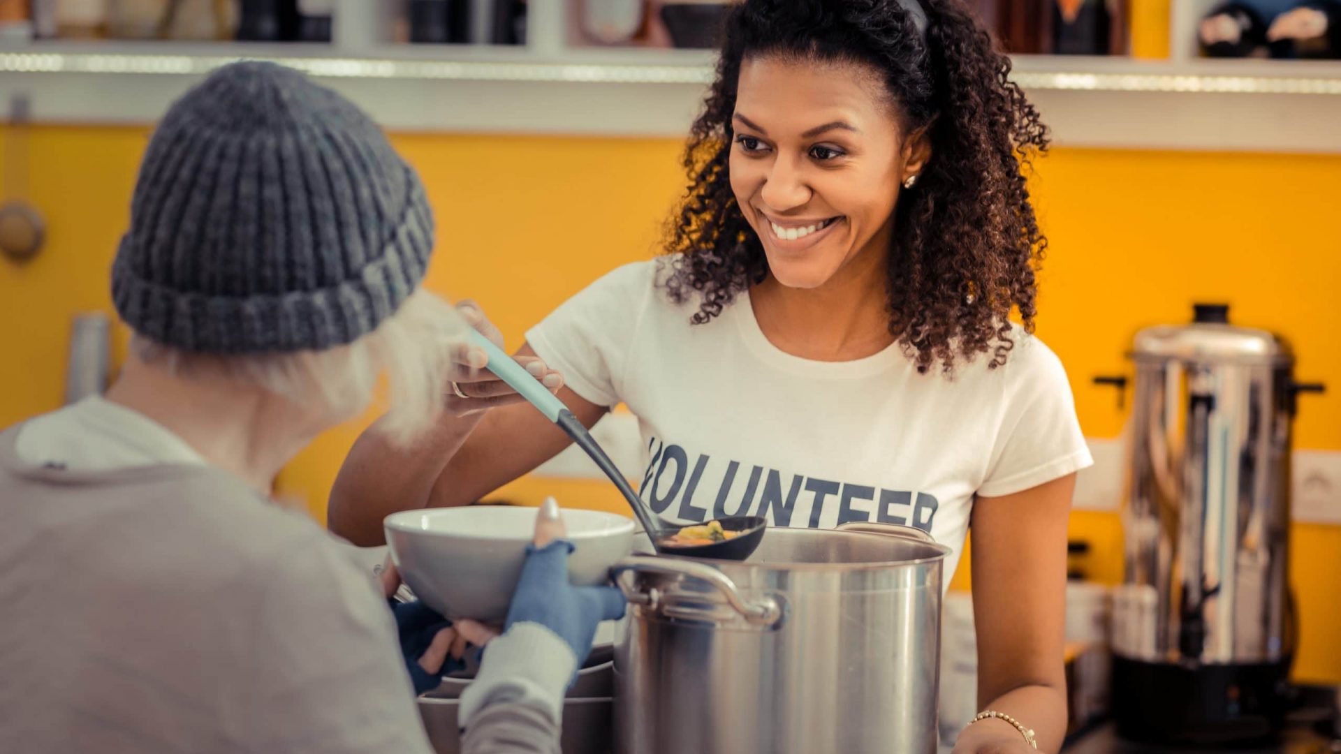 Being a volunteer. Nice friendly woman smiling while enjoying her job as a volunteer